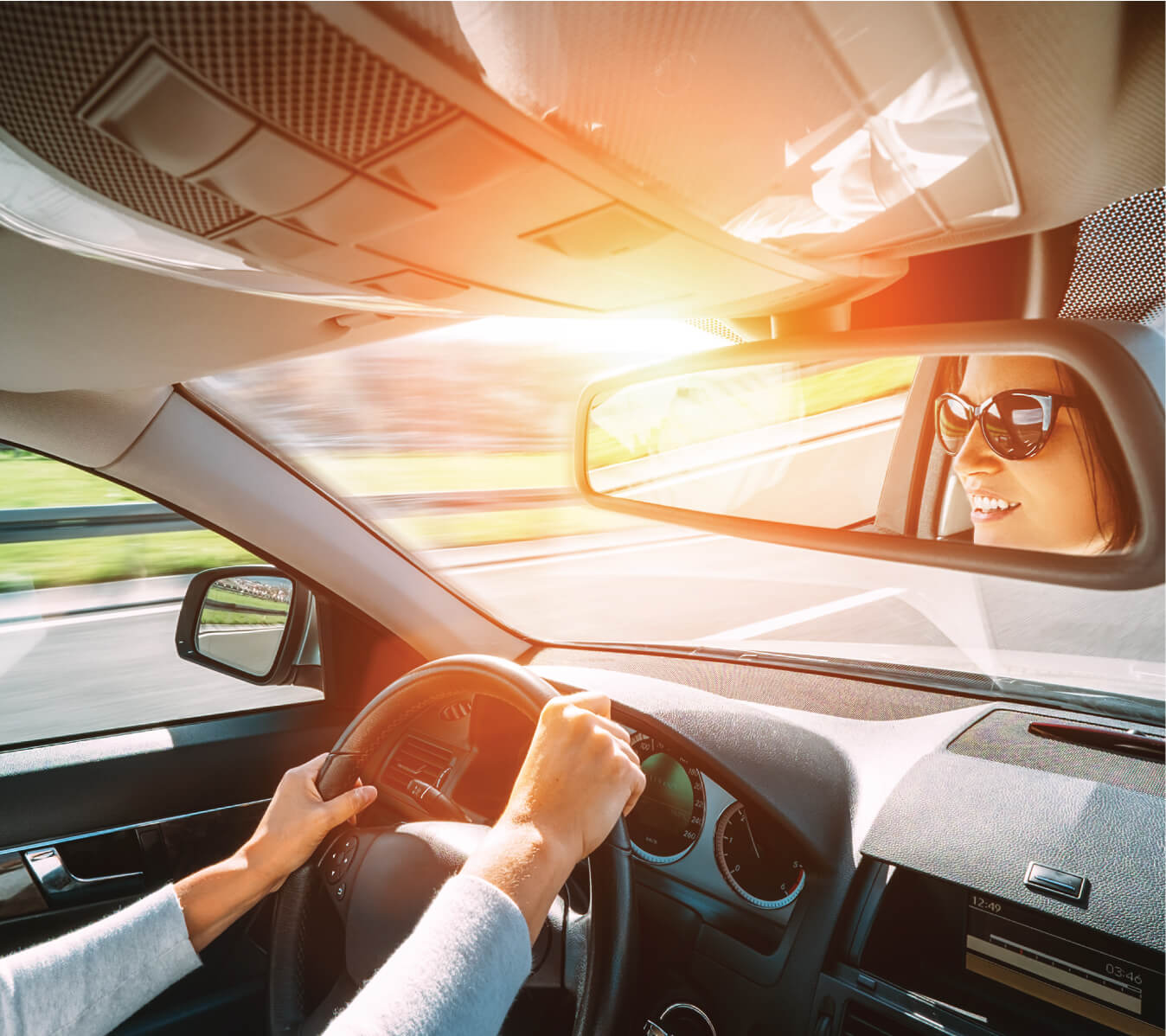 Interior image of woman driving her car on the highway in summer. 